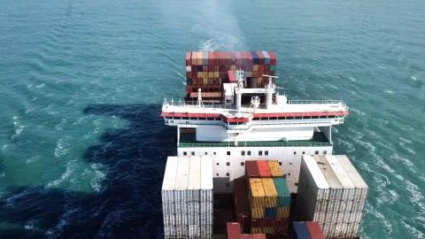 Huge large mega ULCV container ship sails on open water fully loaded 스톡 사진
