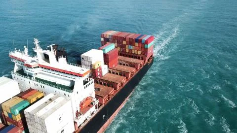 Huge large mega ULCV container ship sails on open water fully loaded Foto stock