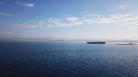 Huge large mega ULCV container ship sails on open water fully loaded Stock Photos