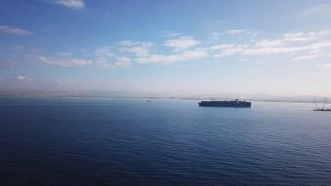 Huge large mega ULCV container ship sails on open water fully loaded Stock Photos