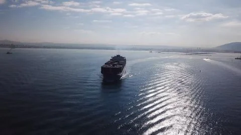 Huge large mega ULCV container ship sails on open water fully loaded Stock Photos