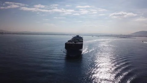 Huge large mega ULCV container ship sails on open water fully loaded Foto stock