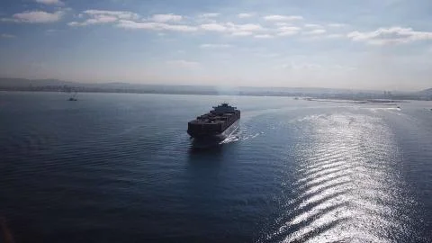Huge large mega ULCV container ship sails on open water fully loaded Stock Photos