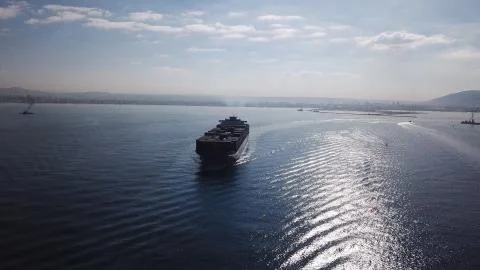 Huge large mega ULCV container ship sails on open water fully loaded Foto stock