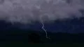 Huge lightning bolts strike above lone country house in valley, storm with sound 4k or 4k+ Resolution