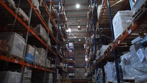 Huge logistic warehouse. Camera movement along high shelves with boxes. 4K Slow Video stock 111765246