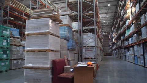 Huge logistic warehouse. Panorama between the rows with shelves. The warehouse Stock Footage 111766102