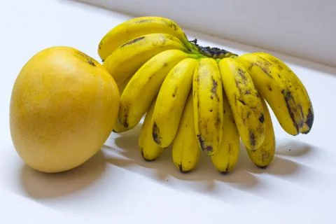 A huge mango and banana in yellow colour. Stock Photos