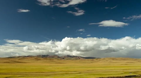 Huge meadow against backdrop of mountains, river and blue sky with clouds Stock Footage 51497147