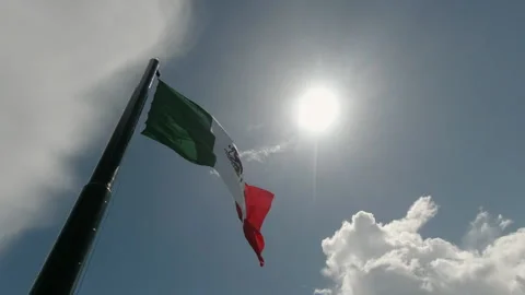 Huge Mexican Flag Waving with the Sun as a backdrop Stock Footage