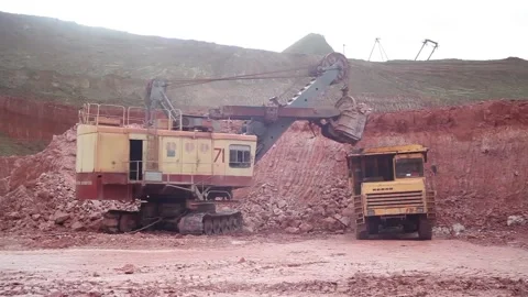 A huge mining excavator loads a large mining dump truck. Stock Footage 122217918