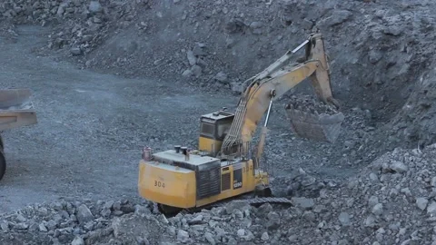 A huge mining truck is approaching a mining excavator for loading. Stock Footage 124192566