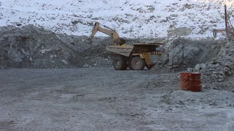 A huge mining truck is approaching a mining excavator for loading. Stock Footage 124192681