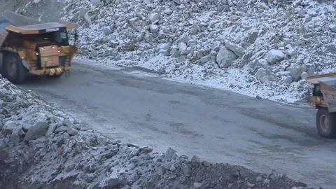 A huge mining truck working in a quarry. Two huge mining dump trucks Stock Footage 122686331