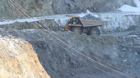 A huge mining truck working in a quarry. A huge loaded mining truck is driving Stock Footage 122686333