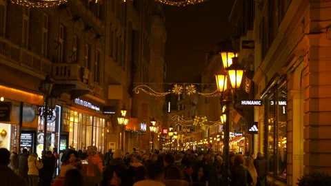 Huge moon installation hanging over crowded city street at night Stock-Footage 332982918