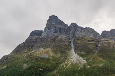 Huge mountain with erosion forms. Steep mountain peak Stock Photos