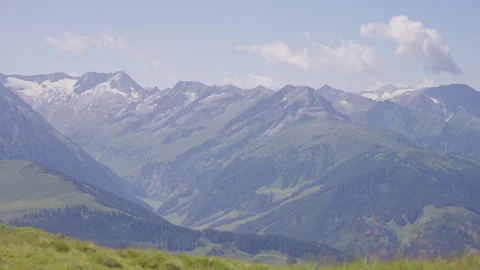 Huge Mountain Range With Snowy Peaks and Clouds Overhead, Extreme Wide Shot Stock Footage 307706451