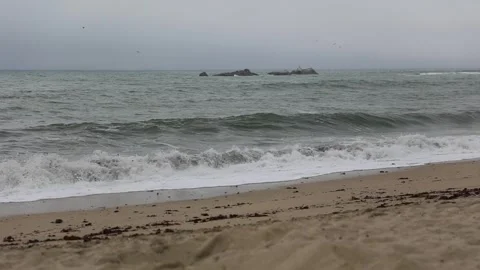 Huge North Pacific ocean waves crush on Half Moon Bay orange sand beach Stock Footage 255577864