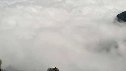 A huge number of clouds under the mountain, view from a very high altitude, a Stock Footage 113229485