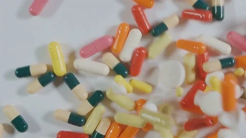 A huge number of pills falling on white background top view. Stock Footage 72881732