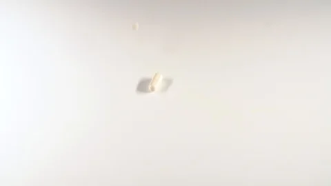 A huge number of pills falling on white background top view close up Stock Footage 127620928