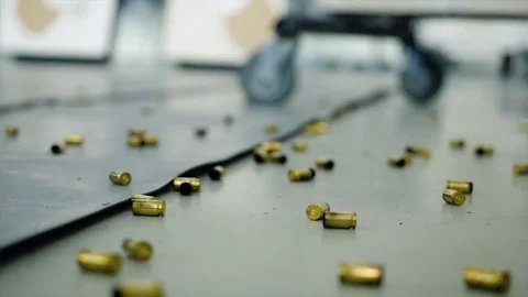 Huge number of shell casings from bullets lying on the floor in the room Stock Footage 82260001