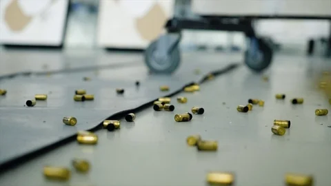 Huge number of shell casings from bullets lying on the floor in the room Stock Footage 82260185