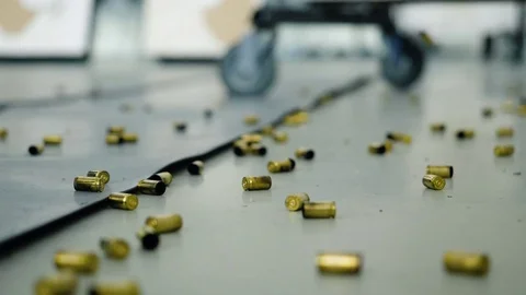 Huge number of shell casings from bullets lying on the floor in the room Stock Footage 82260570