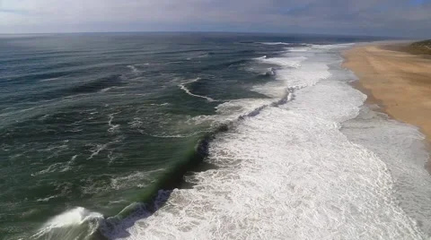 Huge ocean waves on beach in Nazare, Praia do Norte, Portugal Stock Footage