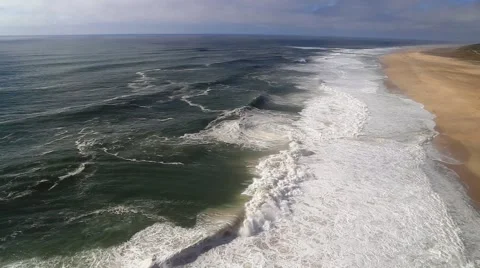 Huge ocean waves on beach in Nazare, Praia do Norte, Portugal Stock Footage 67817044