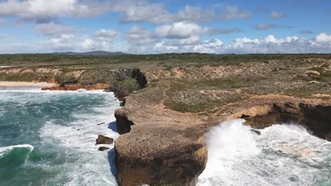 Huge ocean waves crash against the sheer cliff. Fishermen's Trail, Portugal Stock Footage 291451194