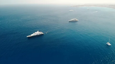 Huge ocean yachts with a deck for a helicopter. The ship of the oligarch. Aerial Video stock 116506048