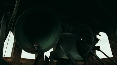 Huge old metal bells ringing inside a historic belfry tower 스톡 동영상 334788435