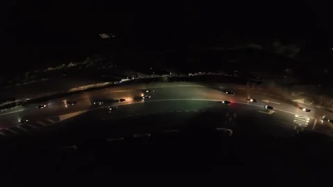 Huge pack of bikers riding at night on a narrow road at night, aerial 動画素材 246349388