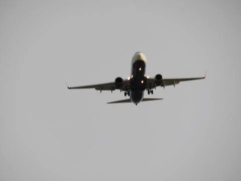 Huge passenger plane flying preparing for landing Stock Photos