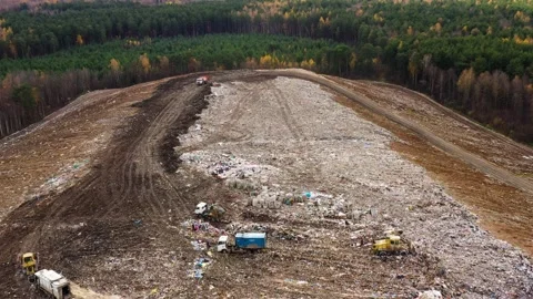 A huge pile of garbage surrounded by forests, a dump of household garbage, top Stock Footage 165256136