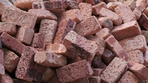 A huge pile of red clay bricks piled in a messy manner Stock Footage 285827189