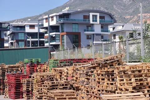Huge piles of different type of pallet at a recycling business area. Stock Photos
