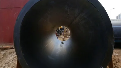Huge plastic sewer pipe PEX, inside view, lying on the sand outside, on the stre Stock Footage 81916822