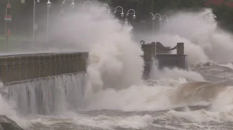 Huge powerful waves breaking at seawall in major severe storm Stock Footage 67571324