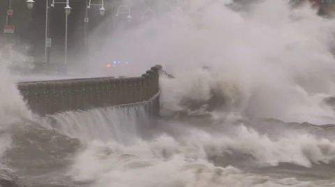 Huge powerful waves breaking at seawall in major severe storm Stock Footage 67571382