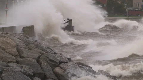 Huge powerful waves breaking at seawall in major severe storm Stock Footage 67571500