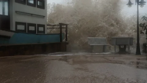 Huge powerful waves breaking at seawall. Tropical hurricane storm floods town Stock Footage 231557378