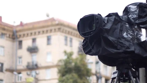 Huge professional digital TV camera in a waterproof case on tripod Stock Footage 79340163