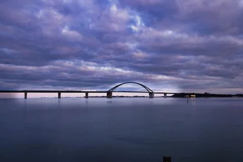 Huge purple cloudscape over the Fehmarn Sound Bridge over the Baltic Sea Stock Photos