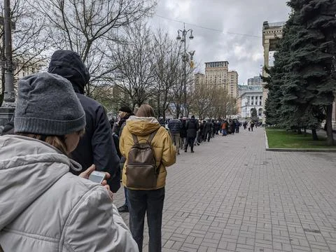 A huge queue of people outside the main post office Stock Photos