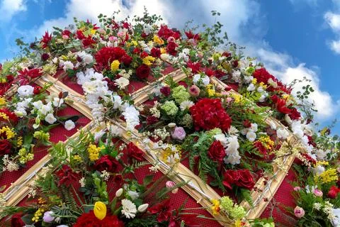 Huge red Easter egg decorated with flowers to decorate streets for holiday... Stock Photos