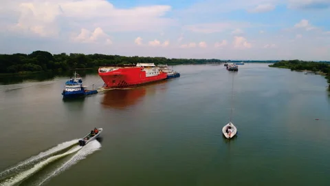 A huge red vessel is towed on the river, designed to perform diving operations  Stock Footage 119511499