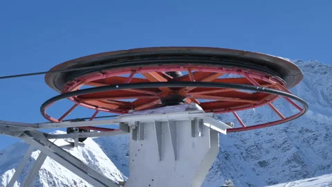 Huge reel with cable rotates to move poma lift at ski resort Stock Footage 150179661